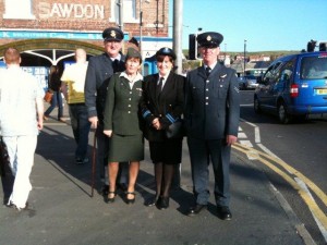 Two couples in wartime clothing at the Whitby Wartime Weekend