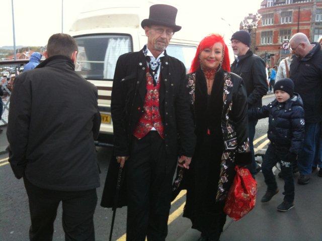 A photo  of a Gothic Couple on the Swing Bridge