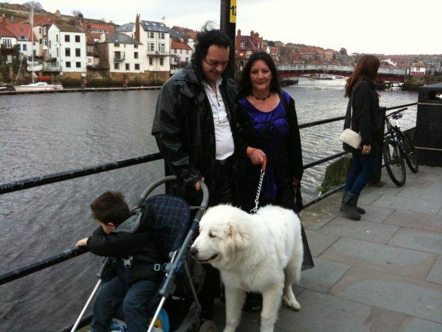 A Gothic couple with a large white dog near Whitby Harbour