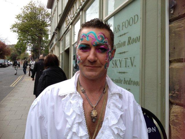 Photo of man with jewels on his face