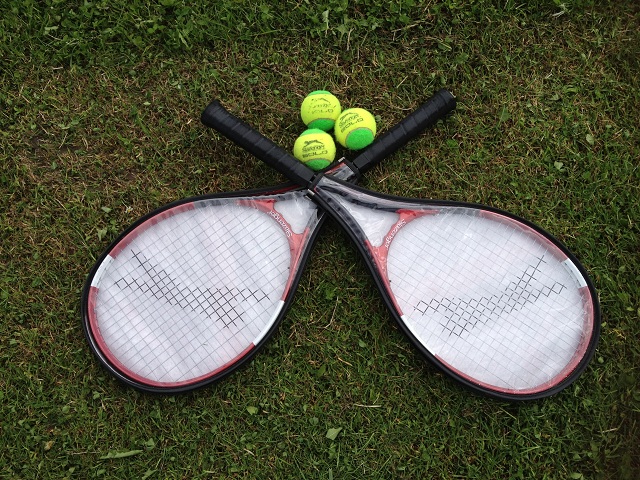 Photo of two tennis rackets and three tennis balls