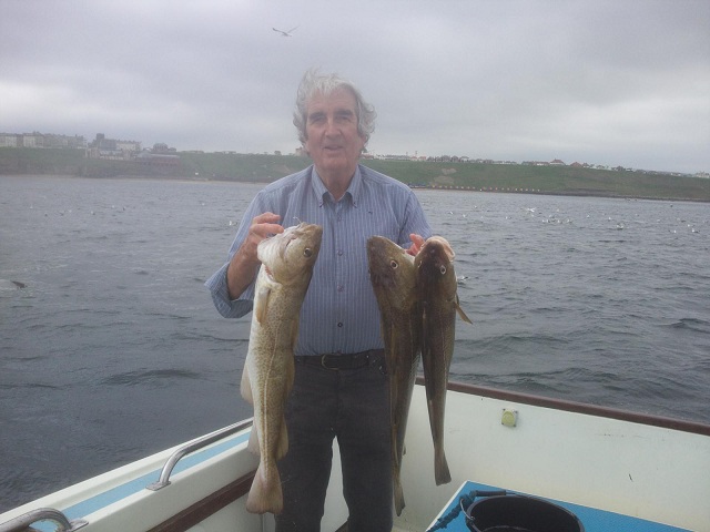 Photo of a fisherman with large cod