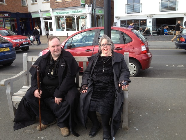 Photo of Goths resting on seat near the harbour