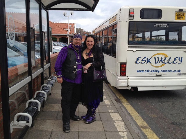 Photo of Gothic couple near the bus stop